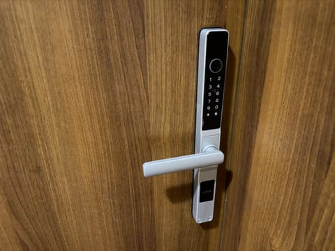 Keypad smart lock on the wooden apartment door